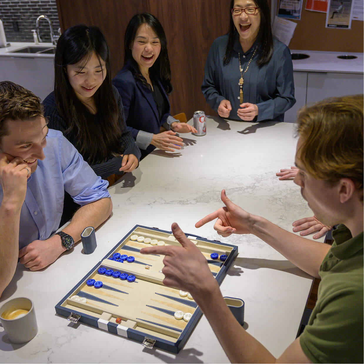A group of Q Team members playing a game of Backgammon together.