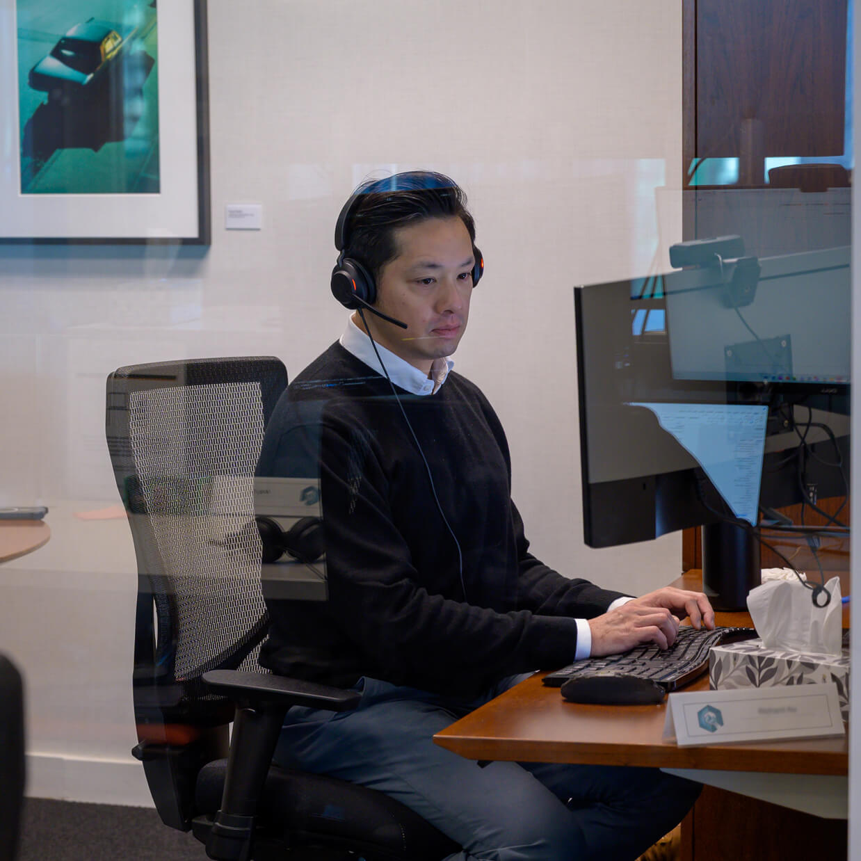 A person on the Q Team working at their desk space.
